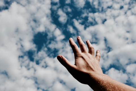 a hand raised to the sky